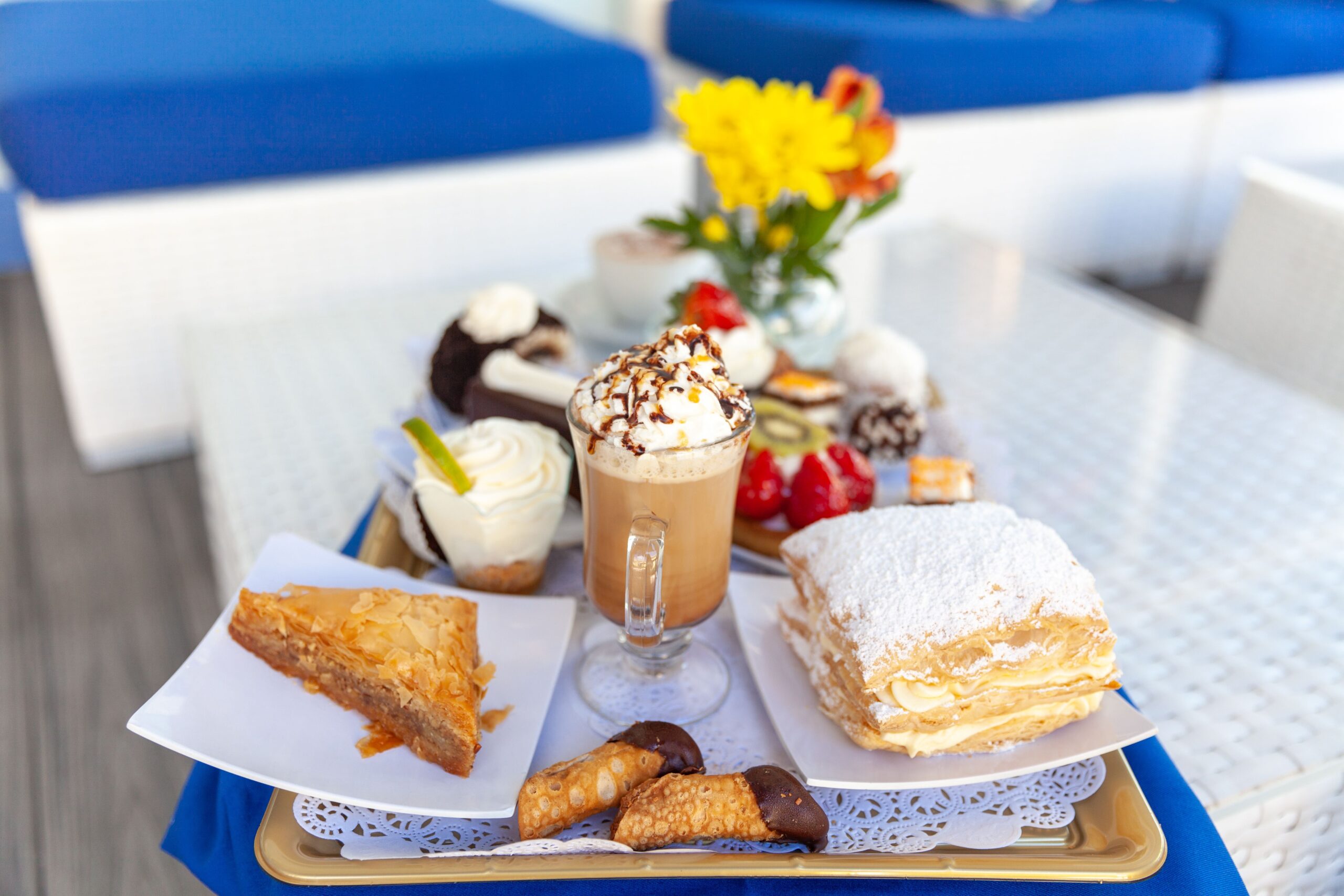 A tempting assortment of desserts with a frothy coffee, perfect for indulgence.