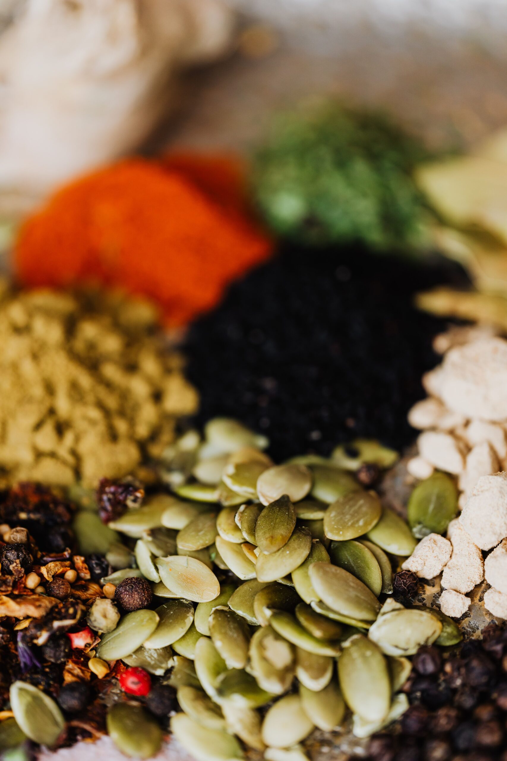 A vibrant close-up of assorted spices and seeds showcasing vivid colors and textures, perfect for culinary themes.